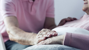 Terminal patient with another person comforting them.